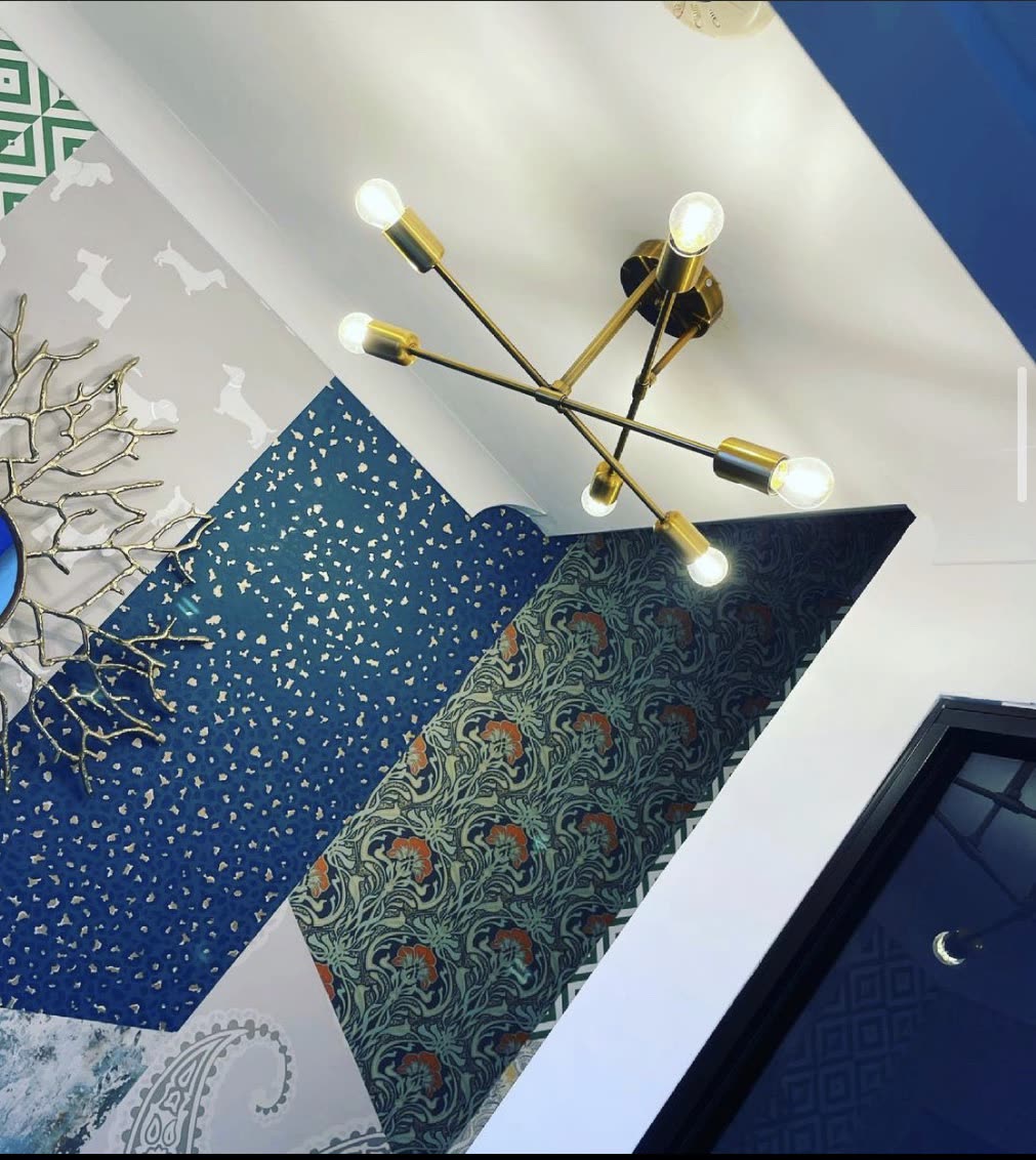 A statement chandelier over a stairwell, fitted at height.