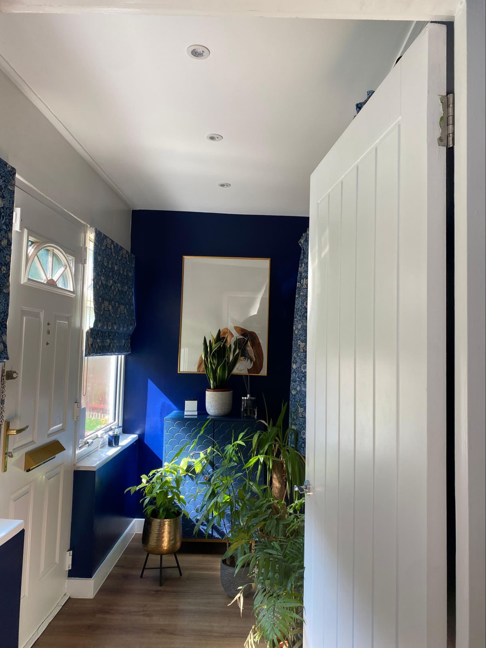 A hallway set off with cool LED accent lighting and downlights.