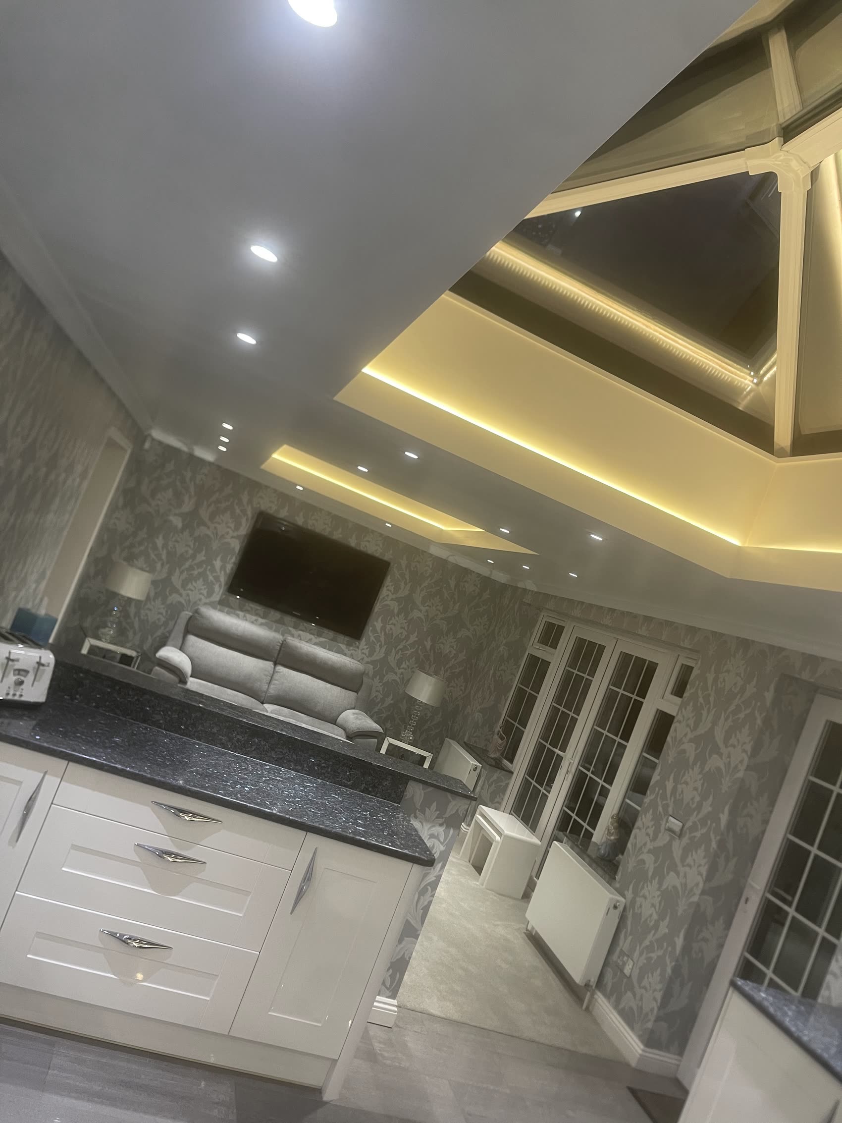 An oak staircase lit with warm LED risers by T&F Electrical